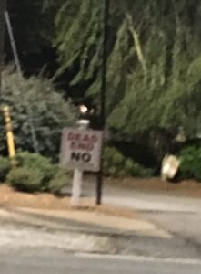 Blurry sign that says "Dead End No"