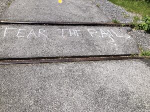 Railway tracks with graffiti "fear the rails"